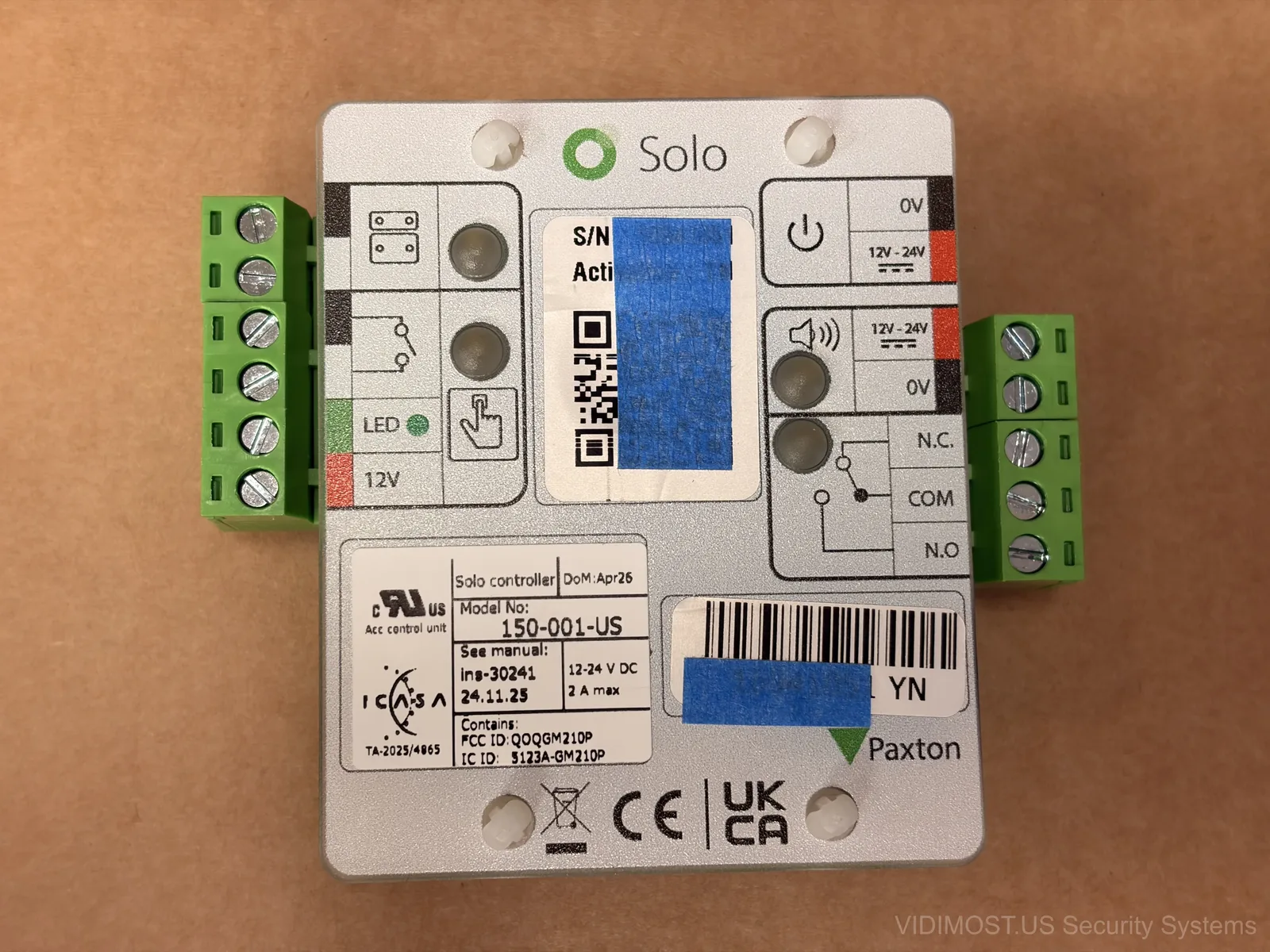 Paxton Solo controller front panel with terminal blocks and QR code label